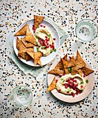 Spicy tortilla chips with pomegranate hummus