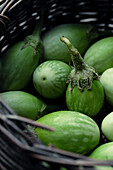 Green aubergines (Thai aubergines) in a basket