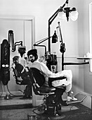 Patients in chairs in a dentist's office, 1930s