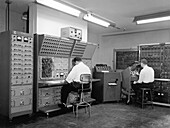 Men working on analogue computer