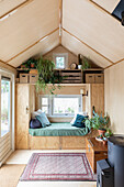 Cosy living area with built-in windowsill and lots of houseplants