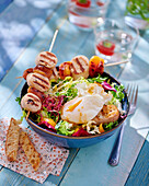 Skewers with boudin blanc and apricots on salad with egg