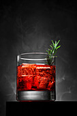 Campari soda on ice, garnished with rosemary