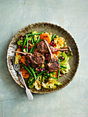 Lamb chops on sweet potato and rocket salad with figs and beans