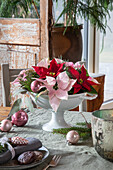 Christmas arrangement of red and pink poinsettias (Euphorbia pulcherrima)