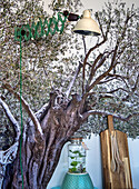 Wall lamp, chopping boards and olive tree mural