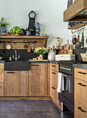 Country kitchen with wooden furniture and dark worktop