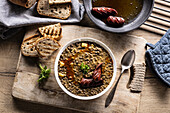 Lentil and potato stew with sausage and bread