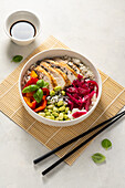 Chicken and pepper poke bowl with edamame and pickled red cabbage
