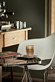 Latte on a bistro table next to an espresso machine