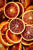 Halved blood oranges (close-up, full frame)