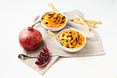 Carrot hummus with pomegranate seeds
