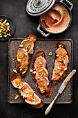 Crostini with duck liver cream, mandarin gel and salted pistachios