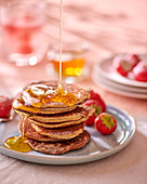 Banana and almond pancakes with maple syrup
