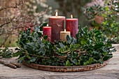 Advent wreath with red winterberry (Ilex verticillata), holly 'Blue Prince' (Ilex meserveae)