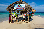 Guides move a shelter on tiny Paradise Island, a small sandbar island on the northwest coast of the Dominican Republic. At high tide, it is completely submerged under a few inches of water.