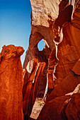 The Eye of the Sun, a natural sandstone arch in the Monument Navajo Valley Tribal Park, Arizona.