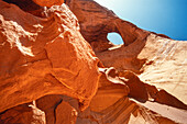 The Eye of the Sun, a natural sandstone arch in the Monument Navajo Valley Tribal Park, Arizona.