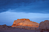 First light on the sandstone monolith in the White Pocket Recreation Area, Vermilion Cliffs National Monument, Arizona. Brain rock or pillow-rock is in the foreground.