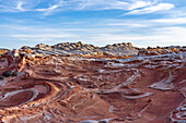 Eroded white pillow rock or brain rock sandstone in the White Pocket Recreation Area, Vermilion Cliffs National Monument, Arizona. Both the red and white are Navajo sandstone but the red has more iron oxide in it.