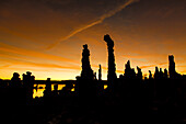 Colorful sunrise silhouettes of tufa formations in Mono Lake in California.