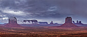 Stormy view of Monument Valley from Artists Point in the Monument Valley Navajo Tribal Park in Arizona. L-R: Merrick Butte, Sentinal Mesa with Eagle Mesa behind, Big Indian Chief with Setting Hen behind, East Mitten with Brigham's Tomb behind, King on his Throne, the Castle, the Bear and the Rabbit and the Stagecoach.