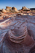 Eroded Navajo sandstone formation in the White Pocket Recreation Area, Vermilion Cliffs National Monument, Arizona. Lollipop Rock is in the background.