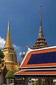 Spires of Phra Sri Ratana Chedi & Phra Mondhop by the Temple of the Emerald Buddha at the Grand Palace complex in Bangkok, Thailand.