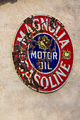 A vintage sign for Magnolia gasoline & motor oil on a building in San Antonio, a small town in rural New Mexico.