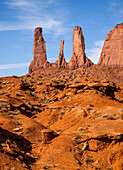 The Three Sisters, sandstone monoliths at the edge of Mitchell Mesa in the Monument Valley Navajo Tribal Park in Arizona.