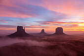 Colorful sunrise with ground fog in the Monument Valley Navajo Tribal Park in Arizona.