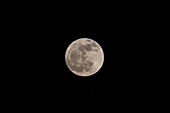 A full moon photographed with a telephoto lens over Utah.