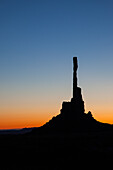 The Totem Pole in silhouette before dawn in the Monument Valley Navajo Tribal Park in Arizona.