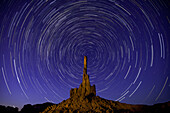 Star trails over the Totem Pole at night in the Monument Valley Navajo Tribal Park in Arizona.