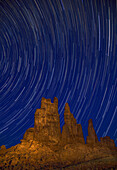 Star trails over the Yei Bi Chei at night in the Monument Valley Navajo Tribal Park in Arizona.