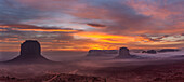 Colorful sunrise over Merrick Butte, Elephant Butte & Spearhead Mesa in the Monument Valley Navajo Tribal Park in Arizona.