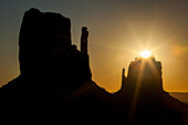 Sun over the East Mitten in the Monument Valley Navajo Tribal Park in Arizona