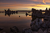 Colorful sunrise views of tufa formations in Mono Lake in California. Note the fog on the lake surface in the background.