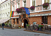 A sidewalk cafe and hotel on Pilies Street in the historic Old Town of Vilnius, Lithuania. A UNESCO World Heritage Site.