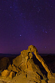 Elephant Rock, a natural arch in the eroded Aztec sandstone at night in Valley of Fire State Park in Nevada.