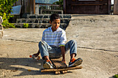 A Dominican boy rides his homemade skateboard near Constanza in the Dominican Republic.