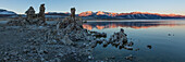 Tufa formations in Mono Lake in California at dawn with the Eastern Sierra Mountains in the background.