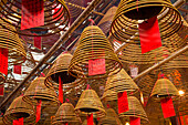 Burning incense coils send prayers to heaven in the Man Mo Temple, a Buddhist temple in Hong Kong, China.