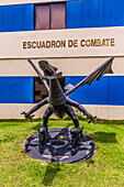 A dragon statue carrying rockets and bombs, the mascot of the combat squadron at San Isidro Air Base, Dominican Republic.