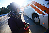 Young woman waiting for the bus in Rovaniemi Station, Lapland
