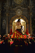 Holy week procession enters Colegiata de San Justo y Pastor in Granada, Spain