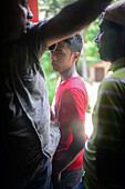 Travellers stand by train door, Sri Lanka