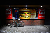 Bike parked by burger restaurant at night, Rovaniemi