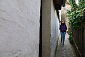 Young woman walking in a narrow street of Szentendre, Hungary