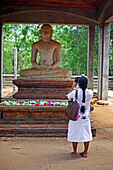 Betende Frau vor der Samadhi-Buddha-Statue in Anuradhapura, Sri Lanka